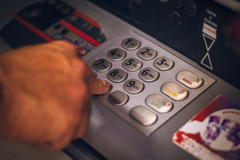 Person paying with a travel rewards credit card at a cafe overseas