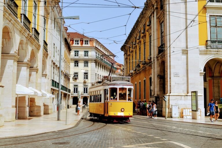 Yellow tram climbing a hill in Lisbon, Portugal, a top destination for American expats