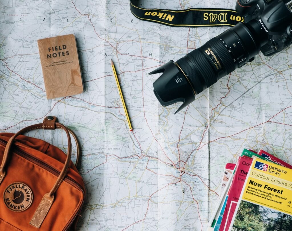 US passport, world map and travel notebook laid out while planning a move abroad